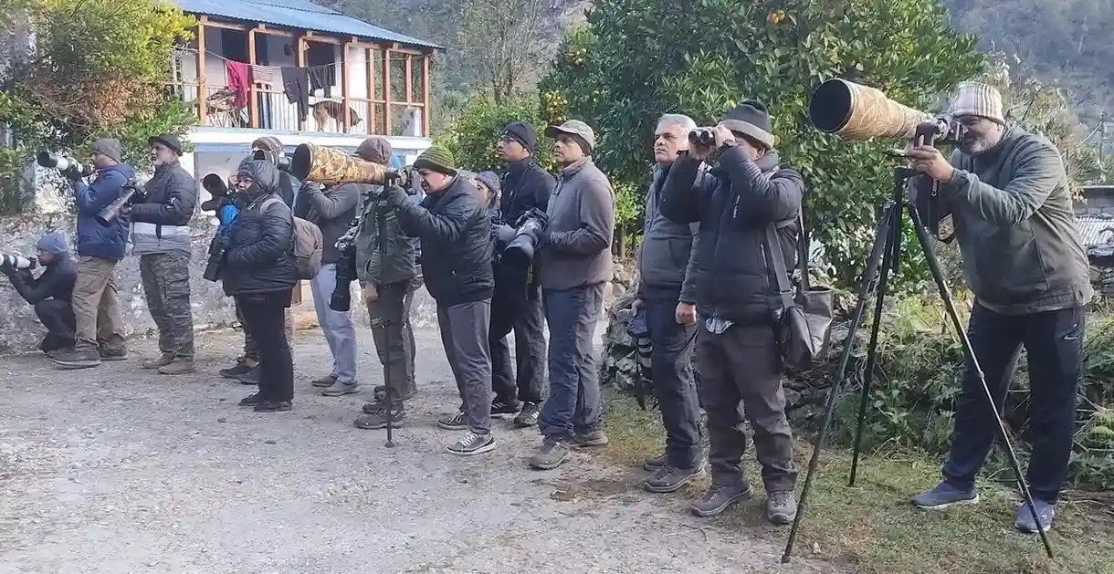 Tour group at Sandakphu summit with Himalayan panorama